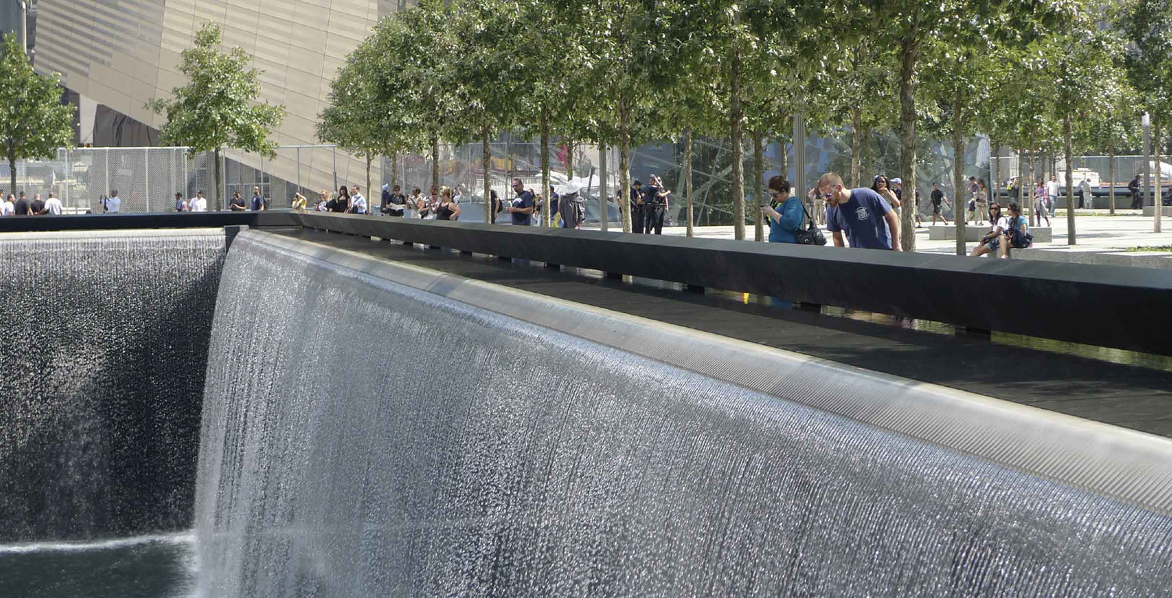 man looking down waterfall at September 11th memorial