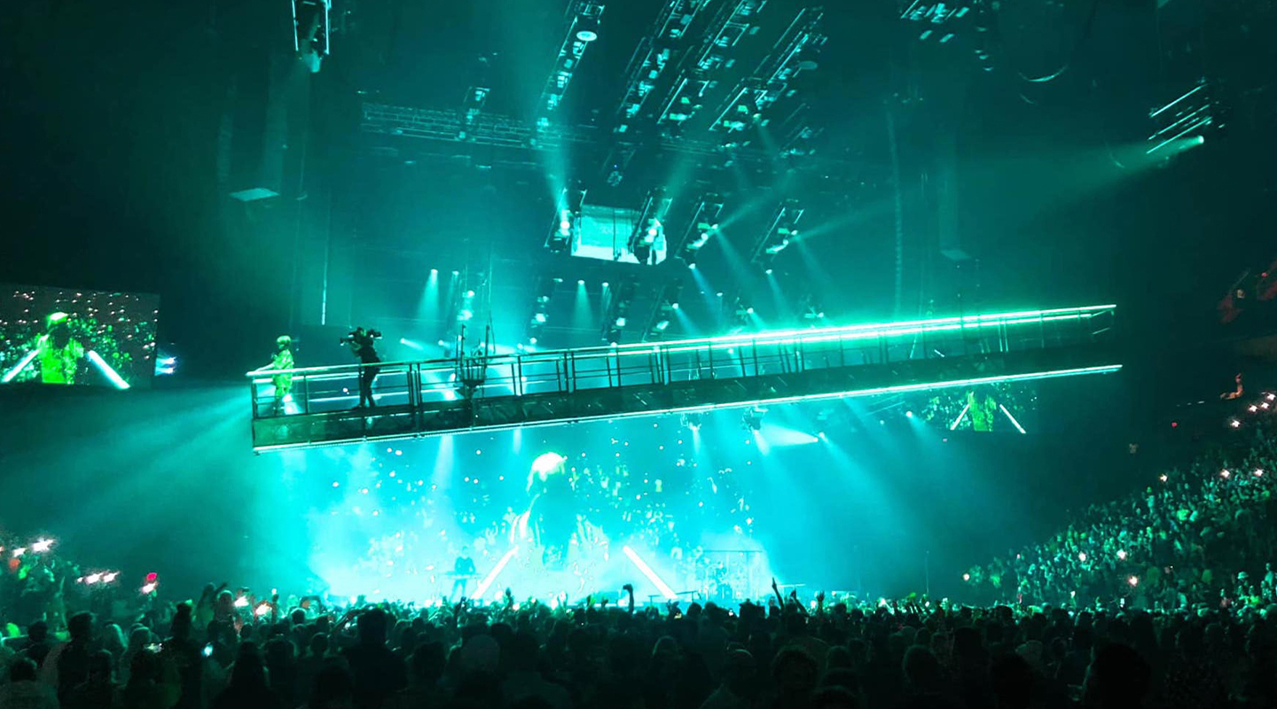 Live shot of a suspended walkway at a Billie Eilish concert.
